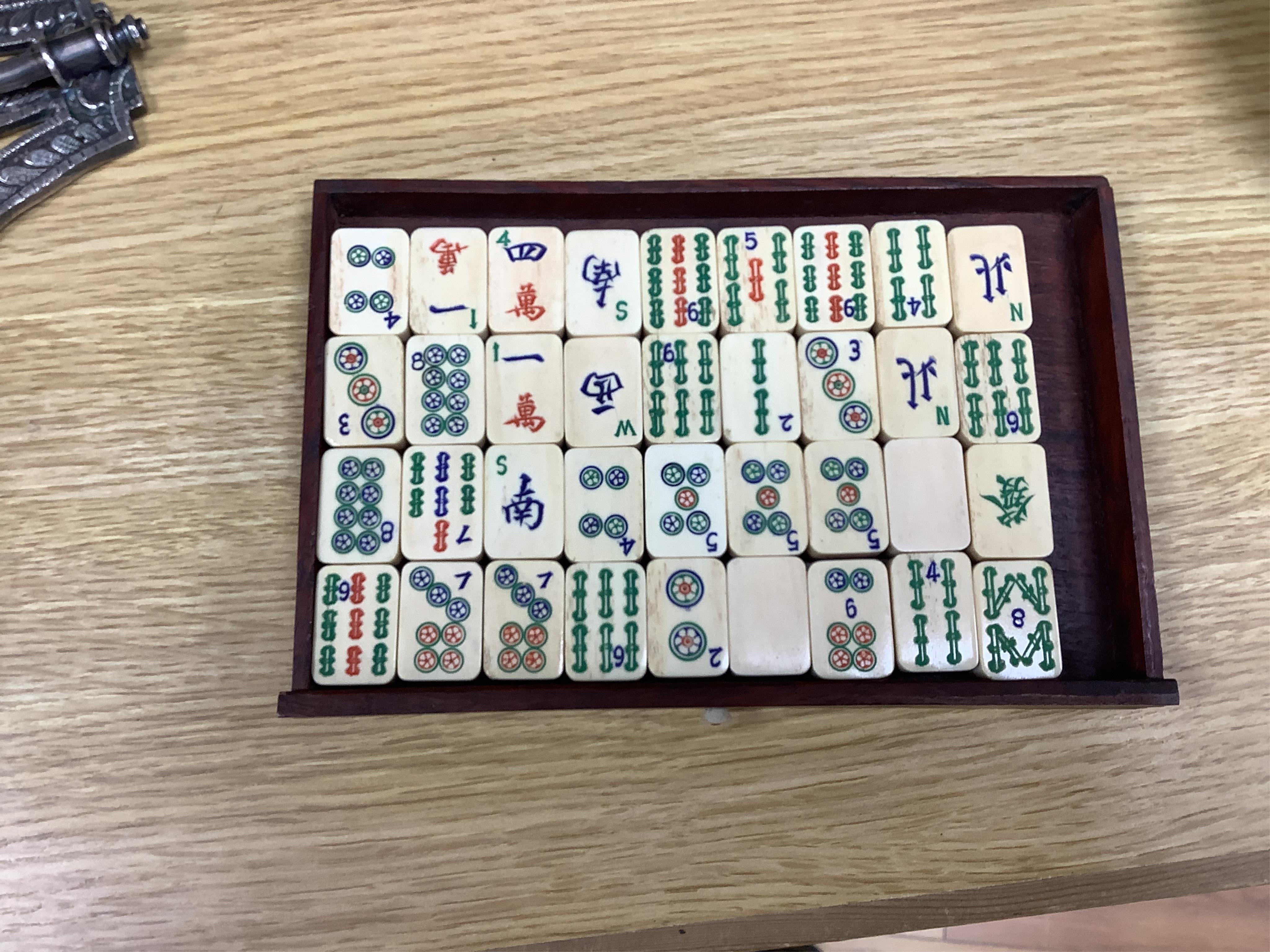 An early 20th century Chinese Mah Jong set, with bone tiles, 22cm x 15.5cm x 14.5cm. Condition - fair, one drawer front replaced